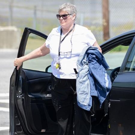 Kelly McGillis Opening her car's door.